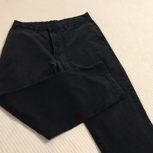 Men’s Perry Ellis chino pants in black.